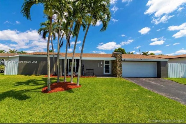 ranch-style house featuring a garage and a front lawn