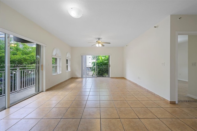 tiled spare room with ceiling fan