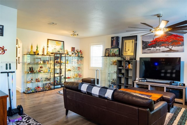 living room with wood-type flooring and ceiling fan