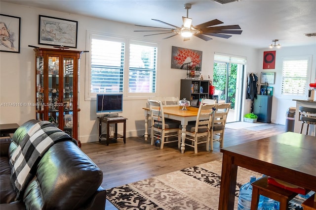 dining area with hardwood / wood-style flooring and ceiling fan