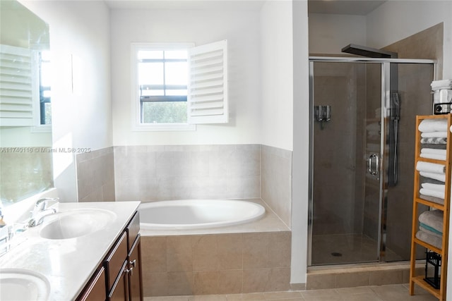 bathroom featuring independent shower and bath, vanity, and tile patterned floors