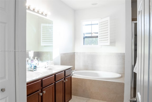 bathroom with tile patterned floors, vanity, and separate shower and tub