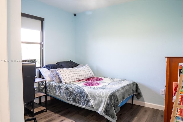 bedroom with hardwood / wood-style floors