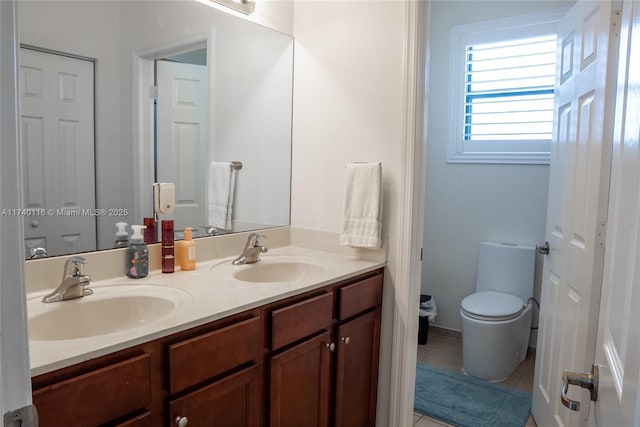 bathroom with tile patterned flooring, vanity, and toilet