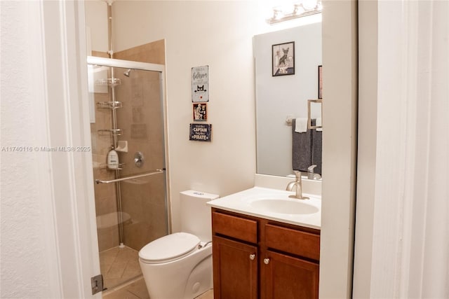 bathroom featuring vanity, toilet, and a shower with door