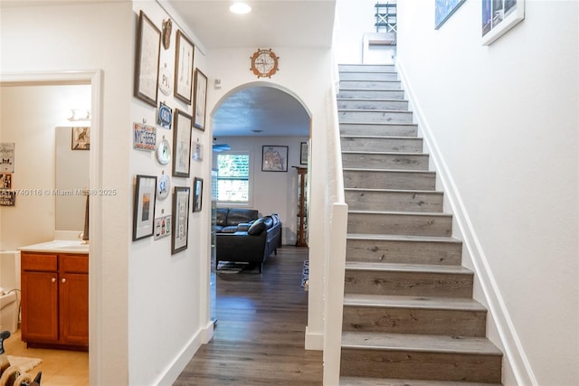 stairs with sink and hardwood / wood-style flooring