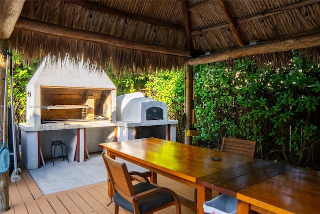 wooden terrace featuring a bar and a gazebo