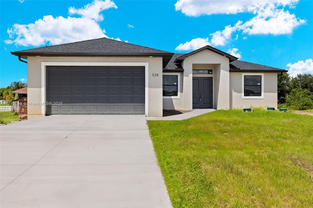 view of front facade with a garage and a front yard