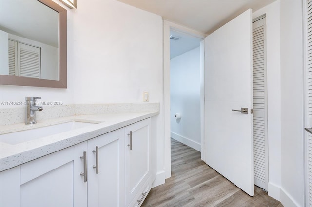 bathroom with vanity and hardwood / wood-style floors