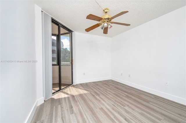 unfurnished room featuring ceiling fan, a textured ceiling, and light wood-type flooring