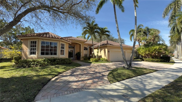 mediterranean / spanish-style house with a garage and a front lawn