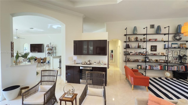 living room with crown molding and beverage cooler