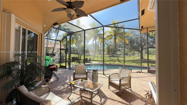 view of patio / terrace with ceiling fan and glass enclosure