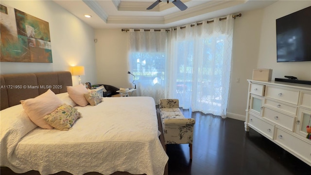 bedroom featuring a raised ceiling, ornamental molding, dark hardwood / wood-style floors, and ceiling fan