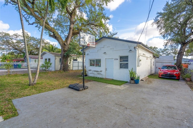 view of front of home with a storage shed and a front yard