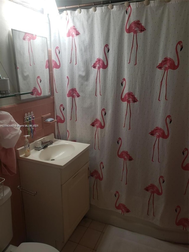 bathroom with vanity, tile patterned floors, backsplash, and toilet