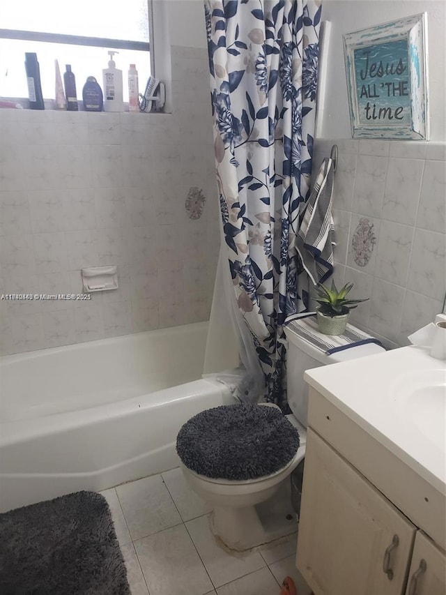 full bathroom with tile patterned floors, toilet, tile walls, vanity, and shower / bath combo