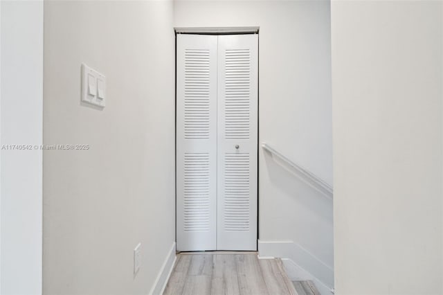 hallway with light hardwood / wood-style flooring