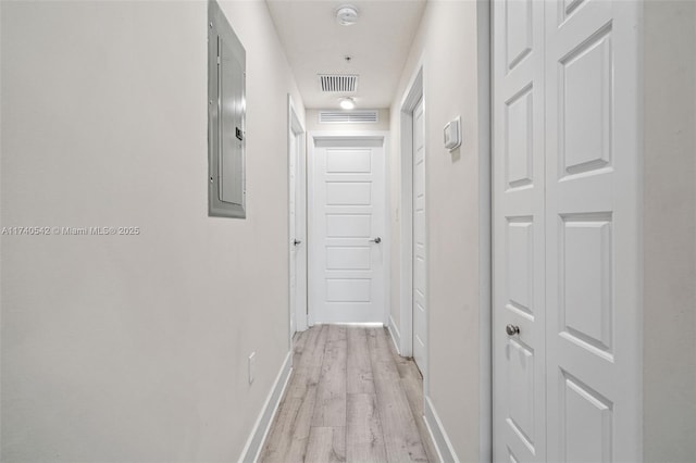 hall with electric panel and light hardwood / wood-style flooring