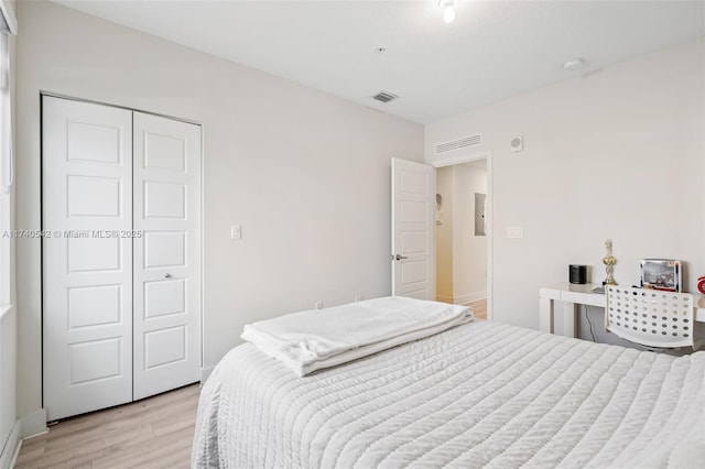 bedroom featuring light hardwood / wood-style flooring and a closet