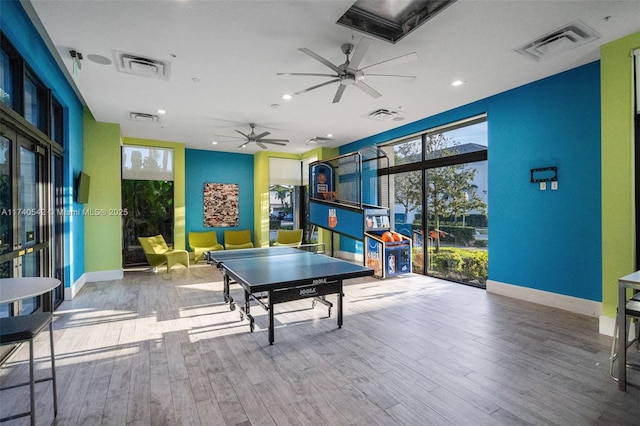 playroom featuring ceiling fan and light hardwood / wood-style flooring