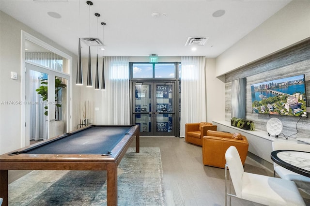 recreation room featuring french doors, billiards, a healthy amount of sunlight, and light wood-type flooring