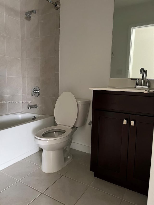 full bathroom with tiled shower / bath, vanity, toilet, and tile patterned floors