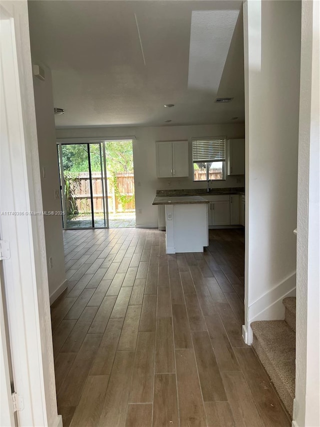 interior space featuring sink, dark hardwood / wood-style floors, and white cabinets