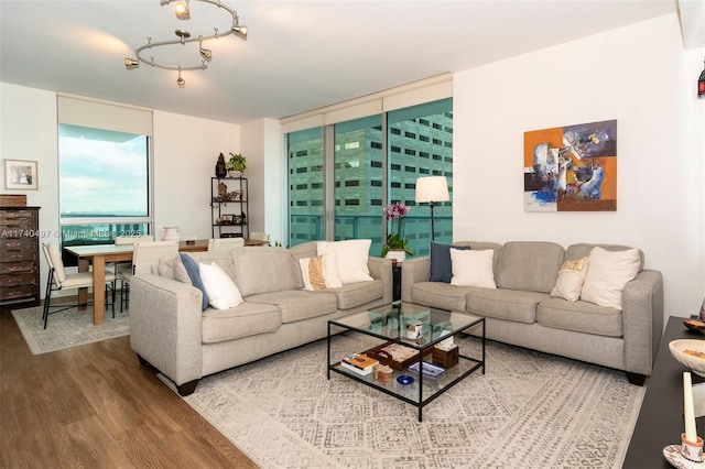 living room featuring wood-type flooring and floor to ceiling windows