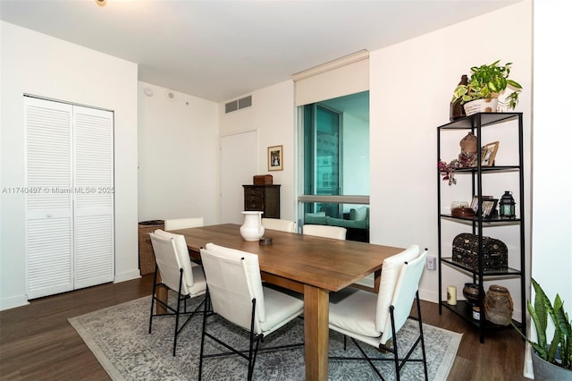 dining area featuring dark wood-type flooring