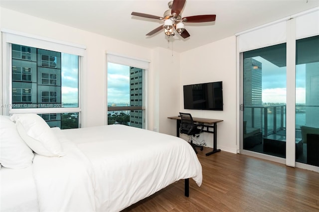 bedroom with dark hardwood / wood-style floors and ceiling fan