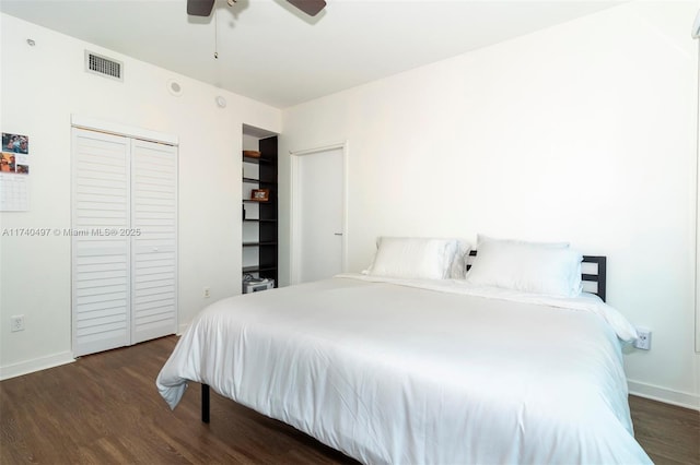 bedroom with ceiling fan, dark hardwood / wood-style flooring, and a closet