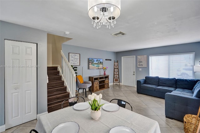 tiled dining space featuring a chandelier