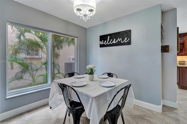 tiled dining space with a notable chandelier