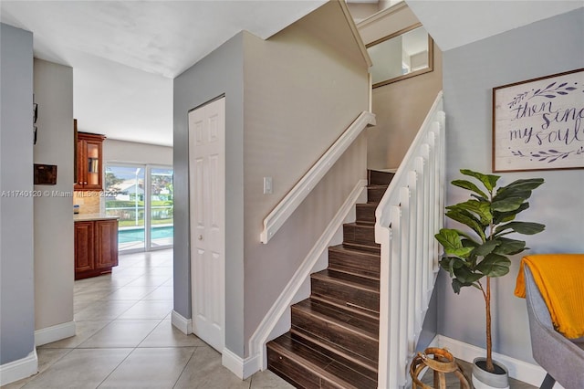 stairway featuring tile patterned flooring