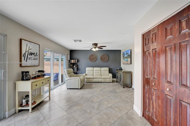 living room featuring light tile patterned floors and ceiling fan