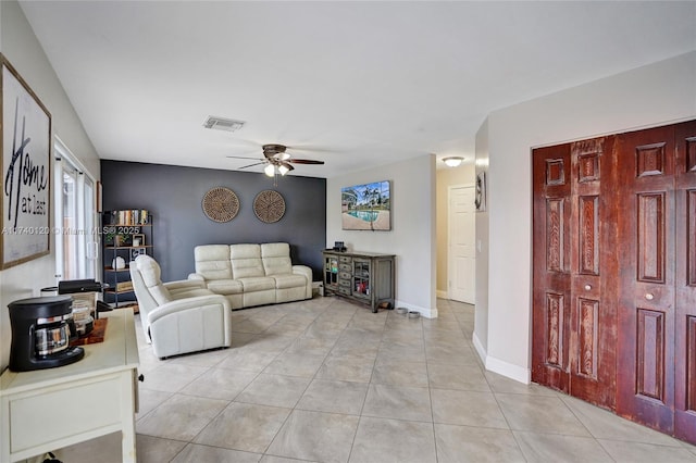 tiled living room with ceiling fan