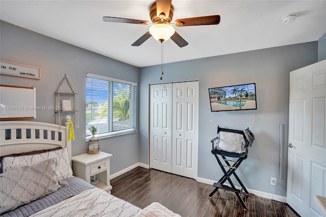 bedroom with ceiling fan, dark hardwood / wood-style flooring, and a closet