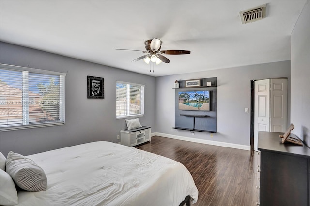 bedroom with dark hardwood / wood-style floors and ceiling fan