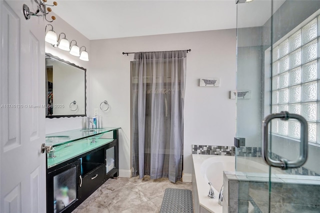 bathroom with vanity and tiled tub