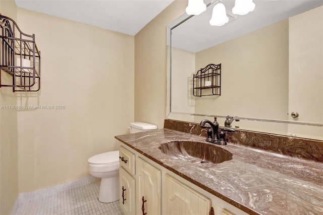 bathroom with vanity, tile patterned floors, and toilet