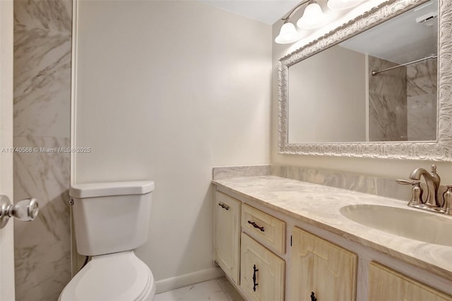 bathroom with vanity, toilet, and a shower