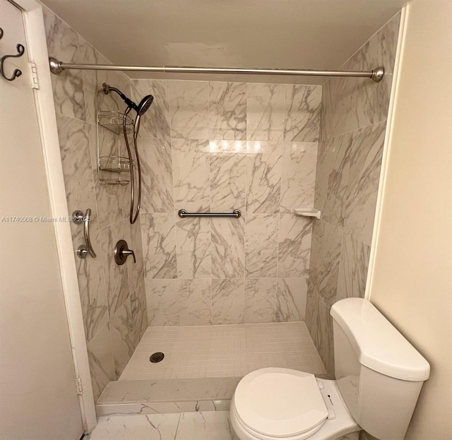 bathroom with tiled shower and toilet