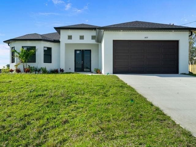 prairie-style house with a front yard and a garage