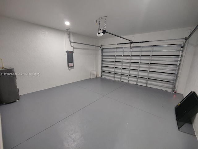 garage featuring a garage door opener, electric panel, and water heater