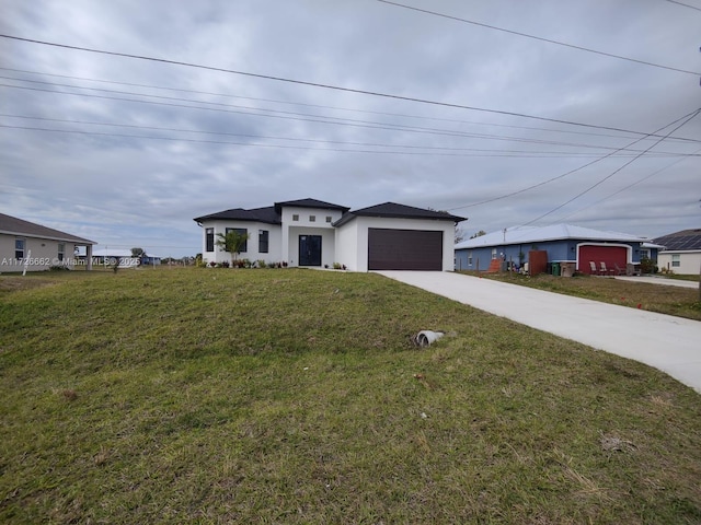 view of front of property featuring a garage and a front yard