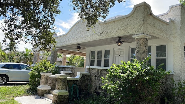 view of side of property with ceiling fan