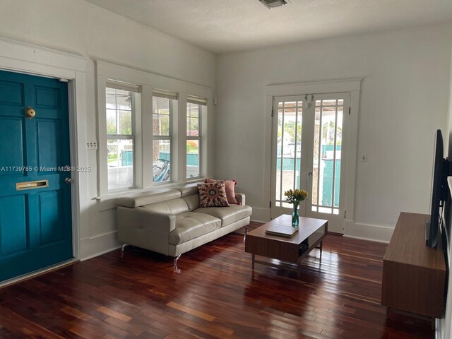 living room with dark hardwood / wood-style floors and ceiling fan