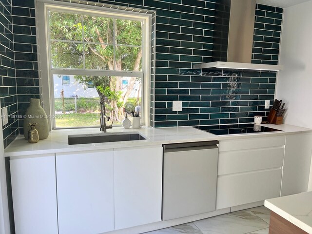 kitchen featuring sink, dishwasher, backsplash, black electric stovetop, and white cabinets