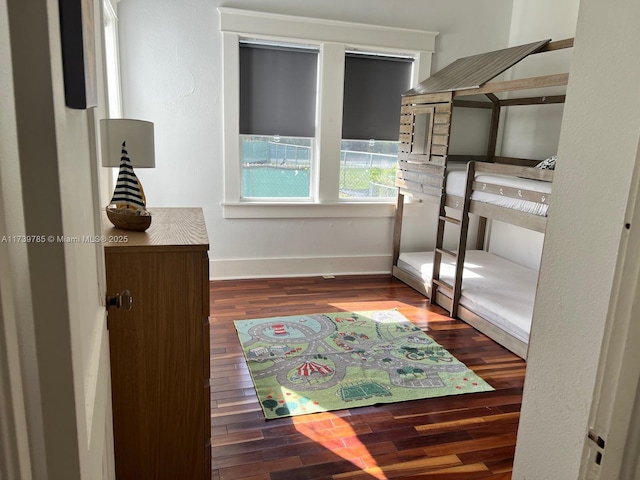 bedroom featuring baseboards and wood finished floors